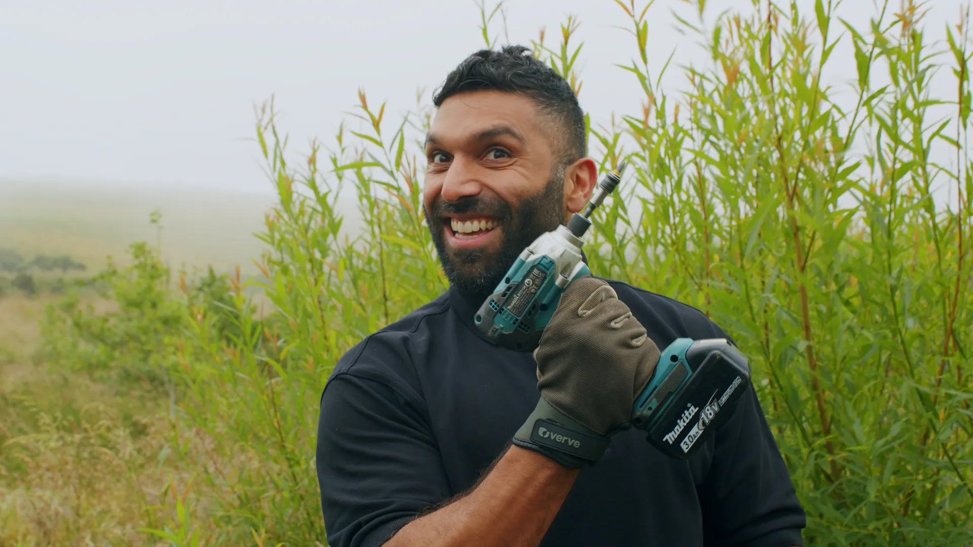 Haseeb Qureshi holding a Makita power drill during the bee safe garden build at The Children's Centre, Isle of Man, filmed by DotPerformance